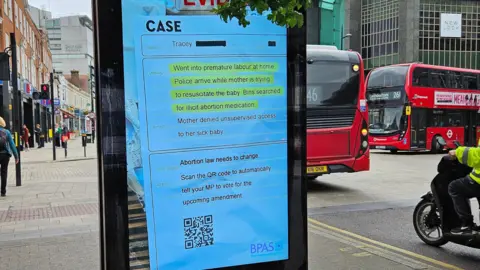 A photo of the BPAS advert on a electronic billboard in London