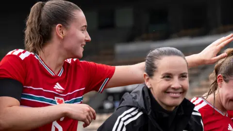 Midfielder Mia Ross (L) and Wales boss Rhian Wilkinson