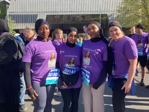 (L-R) Fredrica Arhinsah,  Elihome Gebregiorgis, Swad Abdella and Colette Macdonald all wear purple tee-shirts with an image of their friend Afaf Ahmed.