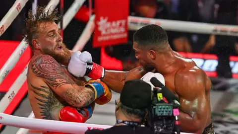 Jake Paul and British boxer Anthony Joshua trade punches during their non-title heavyweight bout at the Kaseya Center in Miami, Florida