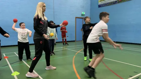 Toby Friedner/BBC Children taking part in an event 