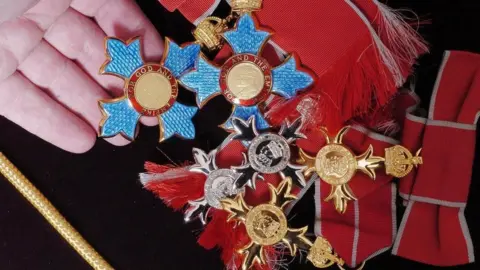 PA Media A selection of honours and awards made from metal