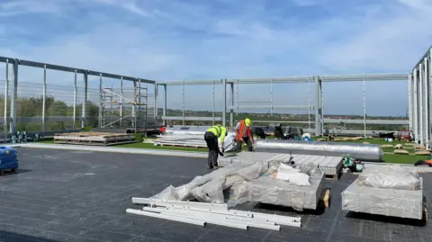 Tom MacDougall/BBC The rooftop football pitch, with a wide view of Barnsley.