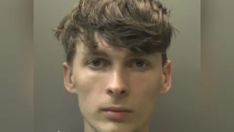 South Wales Police Mugshot of Dylan Thomas who has floppy brown hair