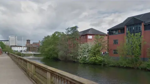 Google Streetview A view across the river to trees and offices which will be cleared