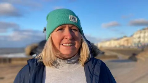 BBC Former Councillor Angela Mulholland speaking to the BBC from the promenade in Portstewart