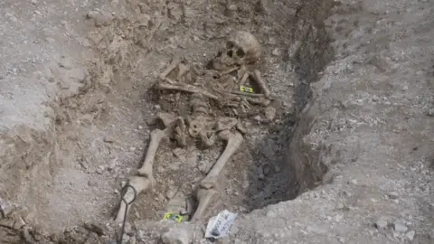 A skeleton in a grave at Bournemouth University, Dorset