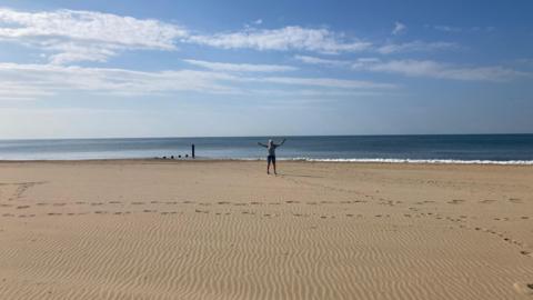WEDNESDAY - A deserted Southbourne beach on a sunny day with footprints in the sand