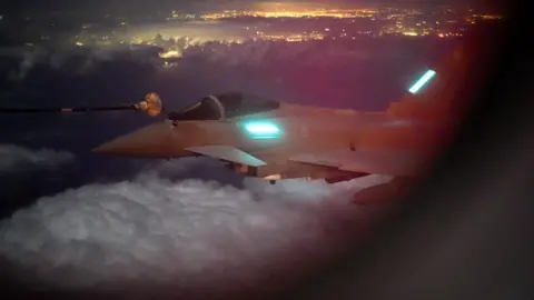 Lee Durant/BBC The RAF Typhoon glides through clouds above RAF Akrotiri in Cyprus.