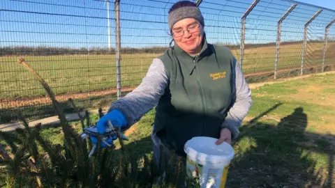 John Devine/BBC Georgina Bailey putting fish into a Christmas tree