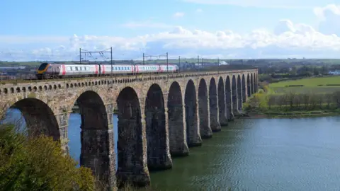 Chris Playfair CrossCountry Voyager train passing Berwick-upon-Tweed on a bridge over a river.