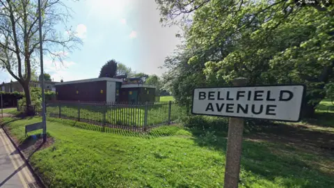 A road sign reading "Bellfield Avenue". 