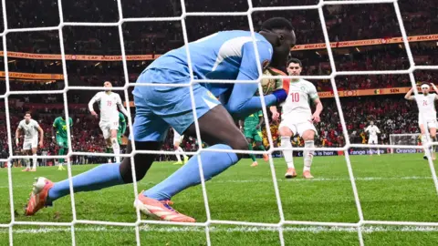 Senegal goalkeeper Eduoard Mendy catches Morocco's Brahim Diaz's Panenka penalty in Africa Cup of Nations final