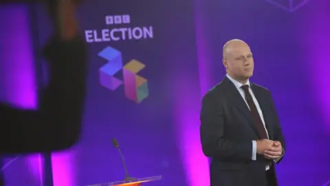 Dan Thomas facing the television audience.