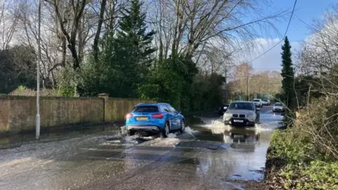 Cars passing each other on a flooded road