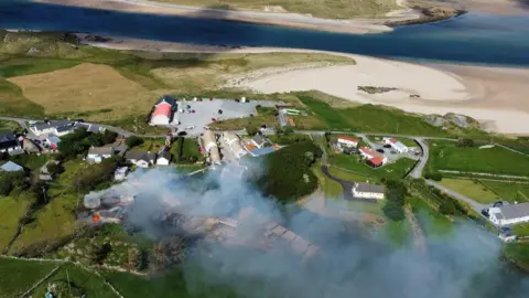 Tony McBride / Online Video Productions A drone camera shot of a stretch of farm land which is covered in smoke