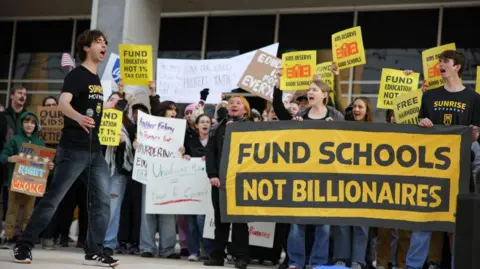 Getty Images A protest against the Department of Education staff cuts on 13 March.