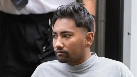 Man with trimmed beard and wearing a grey sweatshirt is pictured outside Cardiff Crown Court