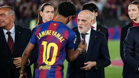 Lamine Yamal of Barcelona shakes hands with Javier Tebas, the president of La Liga