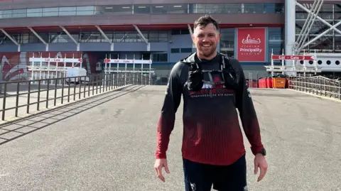 Amber Townson Foundation Glen, who wears a black and red training top and Bristol Bears shorts, stands after a training run outside the Principality Stadium in Cardiff.