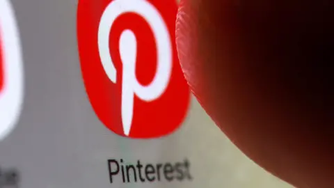 Reuters The red app icon for Pinterest, marked with a stylized letter P, on a smartphone. 