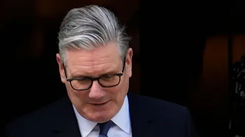PA Media Sir Keir Starmer stands outside of No 10 Downing St.