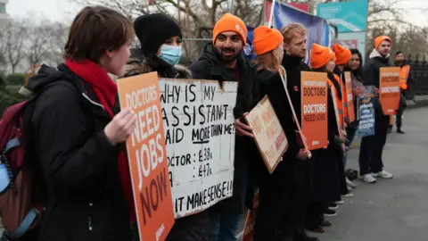 PA Media Resident doctors on the picket line outside St Thomas' Hospital in London, on the first day of a five-day walkout over pay and jobs, which could see up to half of the medical workforce in England could stop work.
