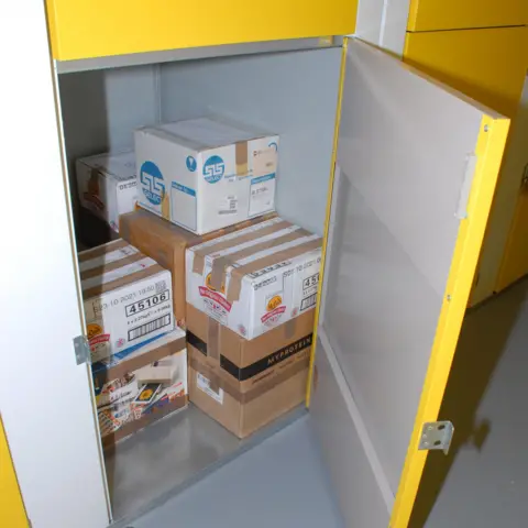 Counter Terrorism Policing East Midlands Boxes stacked behind a yellow door