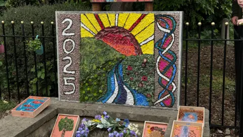 Colourful 2025 decorations placed on the well