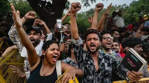 Getty Images Supporters of India's Cockroach Janta Party (CJP) celebrate following the resignation of Education Minister Dharmendra Pradhan, after days of protests demanding he step down over the alleged NEET examination paper leak scandal on July 25, 2026 in New Delhi, India.