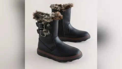 Next Children's short black boots in faux leather with short brown fur lining and black zip. 