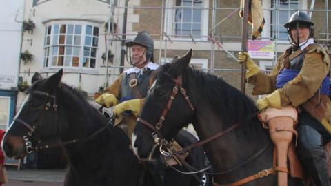 Two Parliamentarian Civil War re-enactors on horseback in Huntingdon town square