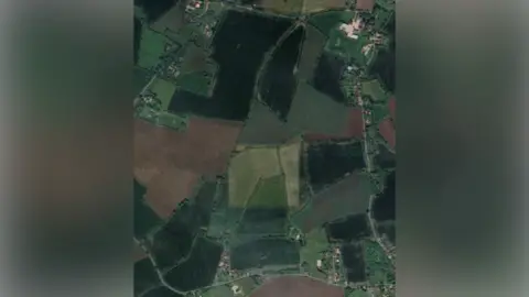 Google An aerial view of farmland where the solar farm could be built. Some rural villages and roads can be seen around the fields.