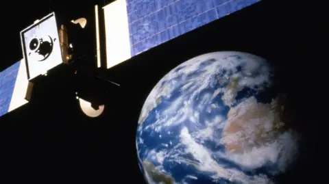 Stock shot of a satellite floating in space, looking to Earth.