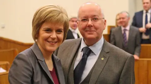 PA Media Nicola Sturgeon with Peter Murrell as she was officially sworn in as first minister in the Court of Session in 2014.