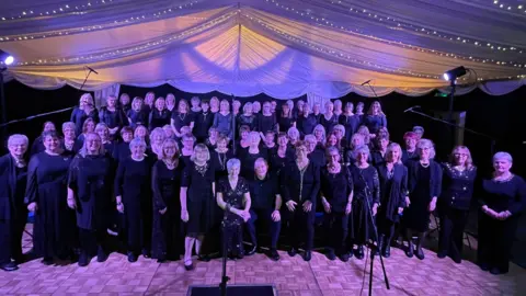 Major Oak Pop Choir A view of Mrs Daglish surrounded by all the members of the Major Oak Pop Choir at their latest performance on 7 December.