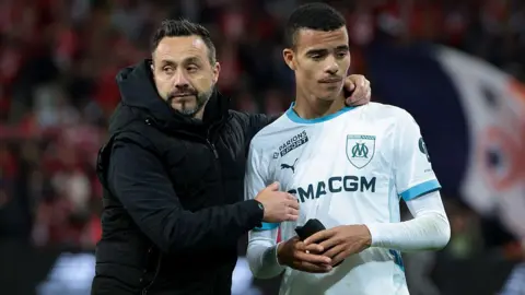 Roberto De Zerbi talks to Mason Greenwood following a Ligue 1 football match between Lille and Marseille