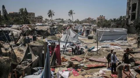 Getty Images Destroyed tents at the site of an Israeli airstrike on a Palestinian refugee camp in the Al-Mawasi district of Khan Younis, southern Gaza, on Saturday, July 13, 2024. 