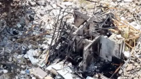 Ruins of bungalow explosion.