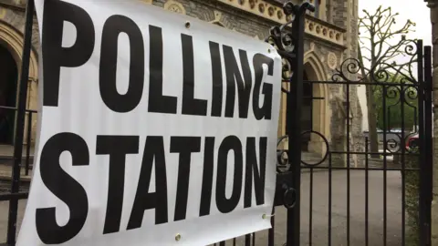 bbc Polling station sign next to church in Bristol