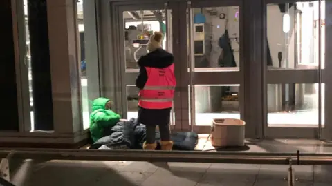 Don't Walk Past Charity volunteer helping rough sleeper in Manchester city centre