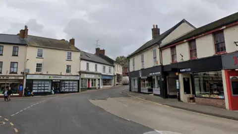 A Google Maps street view screenshot of a road in Ottery St Mary, Devon