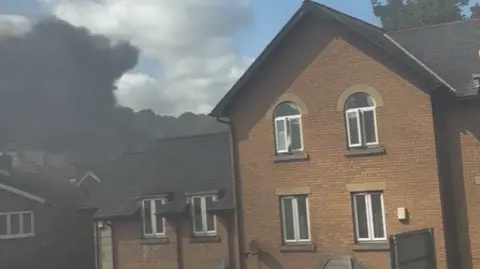 Sammi Evans/Facebook Thick black smoke is seen rising above homes in Scarborough