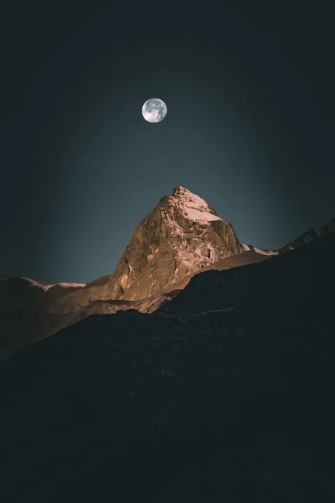 Hannah Hinton The moon over a mountain