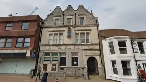 Google A once proud grey 19th Century bank lies empty with a to let sign outside. 