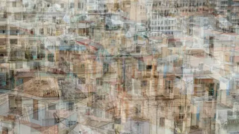 Sue Dyson A view of rooftops in a Mediterranean town. The image is distorted by multiple layers on top of each other.