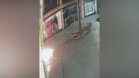 Eastern Region Special Operations Unit CCTV footage shows sparks and flames emitting from a device placed outside a McDonald's restaurant in the Haymarket, Norwich, in the early hours, with a neighbouring Next clothing store shown in the background, which is closed
