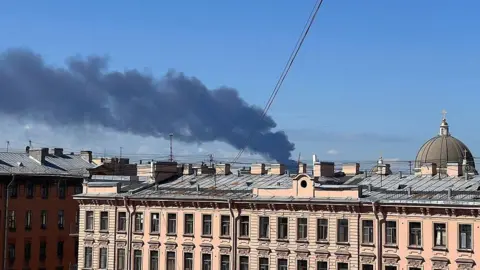 Getty Images Black smoke rises after Ukraine reportedly launched unmanned aerial vehicle (UAV) attacks on the opening day of the St. Petersburg International Economic Forum