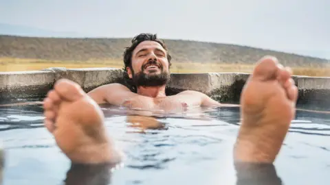 Getty Images Man relaxing in a hot tub