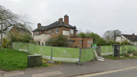 The Oak, a former pub, with fencing around the venue